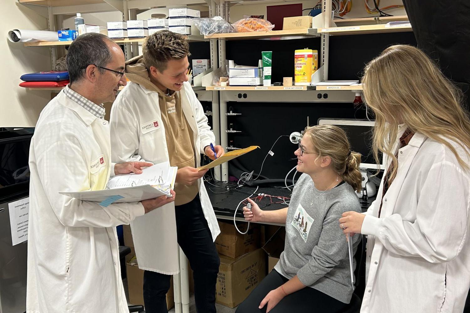 Professor Paul Martino working with biology majors in the neurophysiology laboratory.