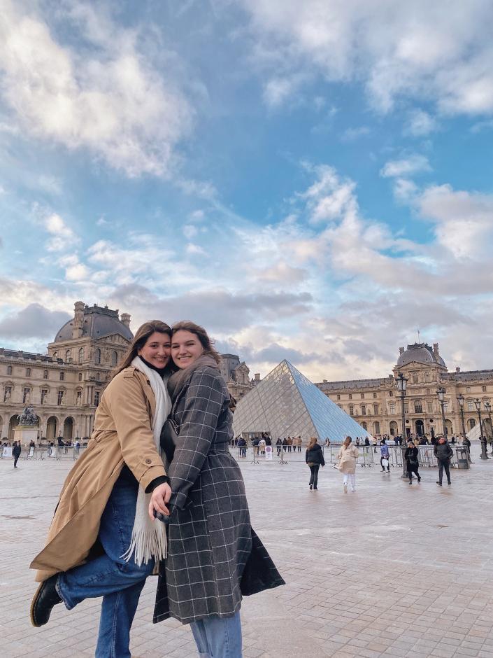 Students in the 2023 Paris study tour pose for a photo outside The Louvre.